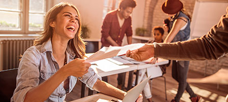 someone handing a document to a woman