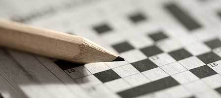 a crossword puzzle with a pencil on top