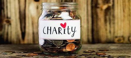 a jar of change that says charity on it