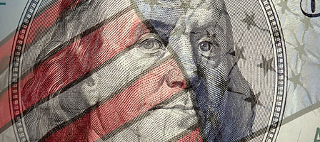 a 100 dollar bill with the american flag overlayed 