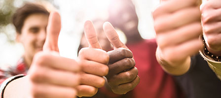 a group of kids putting their thumbs up