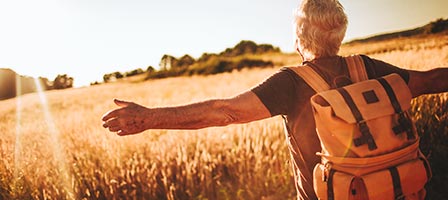 a man basking in the sun standing in a field