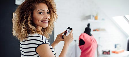 a woman taking a picture of a mannequin 