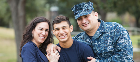 a mom, kids and dad with the dad in a military uniform