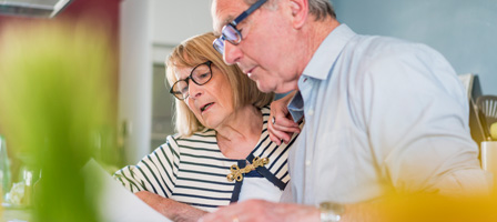 a man and woman looking over some documents