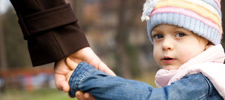 a little girl holding someones hand