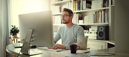 a man sitting at a home office desk