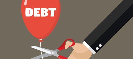 someone cutting the string on a baloon that says debt