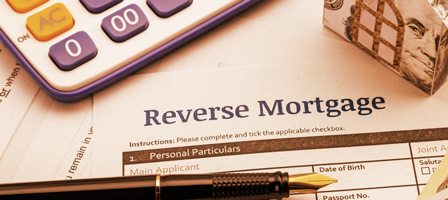 papers that say reverse mortgage with a pen on top