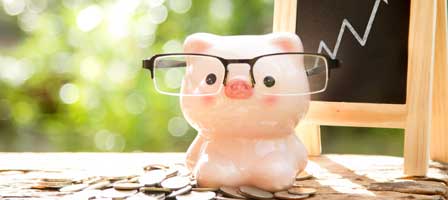 a piggy bank with glasses on