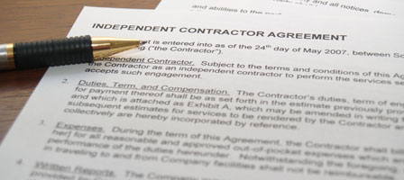 an independant contactor agreement with a pen next to it