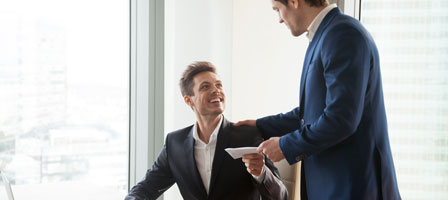 two people exhanging a paper 