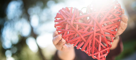 a heart made out of red straws