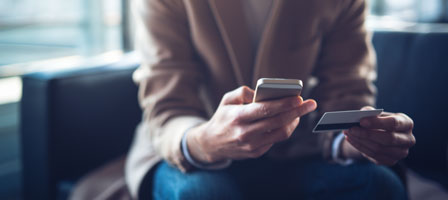 a woman putting card information into her phone