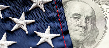 part of an american flag covering a hundred dollar bill