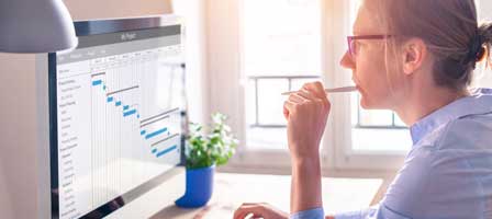 a woman looking at graphs on her desktop