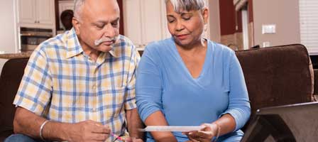 a man and woman looking at a paper