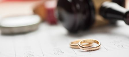 rings and a gavel on top of documents