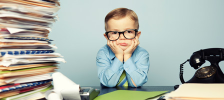 a kid looking sad with a pile of folders next to him