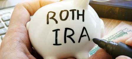 a piggy bank with Roth IRA on the side of it