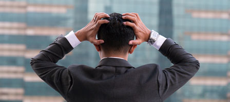 a man holding his hands on his head in frustration