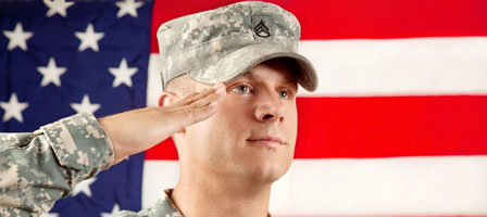 a soldier saluting with the american flag behind it