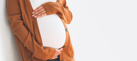 a woman holding her pregnant belly