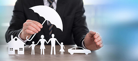 paper cutouts of a family with a man holding a paper umbrella over them