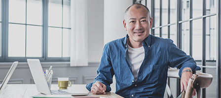 a man sitting at a desk smiling